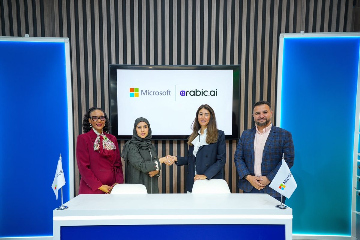 Arabic.ai and Microsoft leaders shake hands at the partnership signing